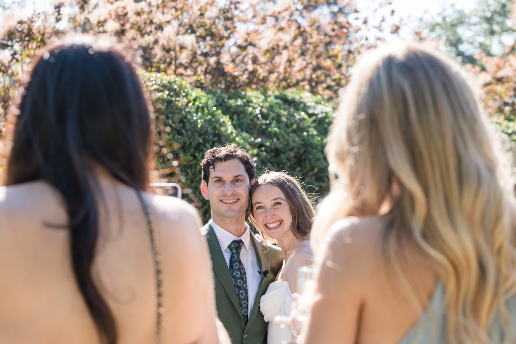 candid framed moment of newlywed couple at cocktail hour