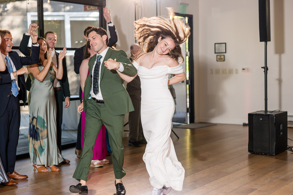 bride and groom waltzing into their first dance