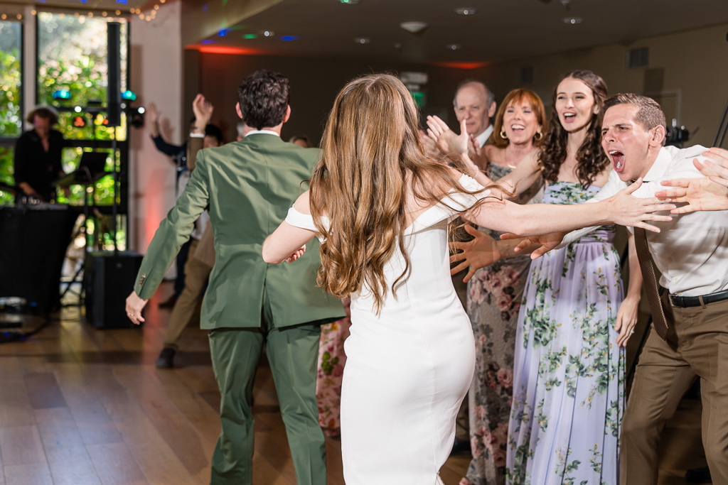bride and groom being greeted by their guests during grand entrance