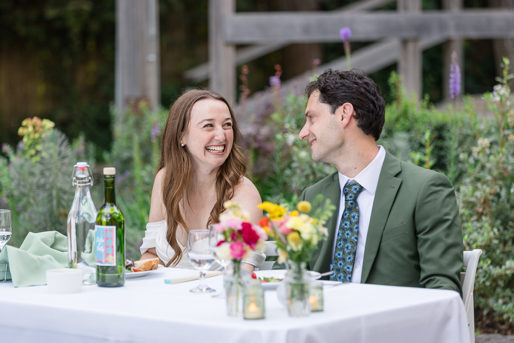 a cute moment between the bride and groom at the sweetheart table