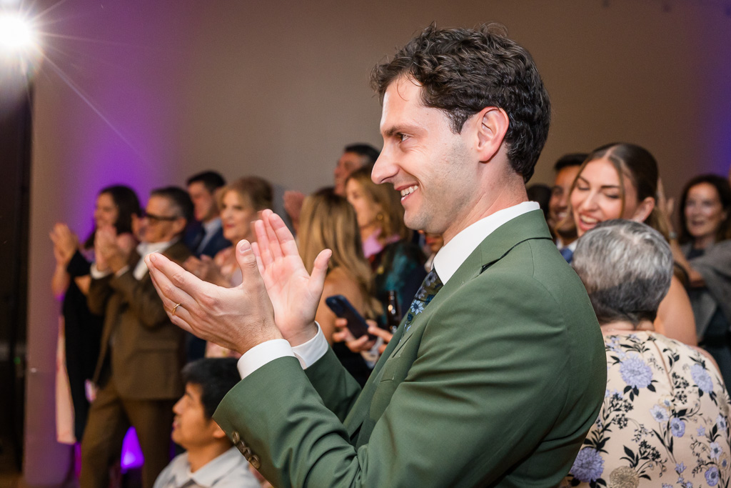 groom clapping for his bride and father in law