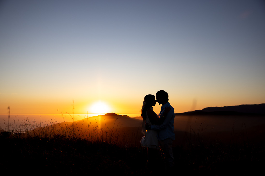silhouette photo of couple in the hills at sunset