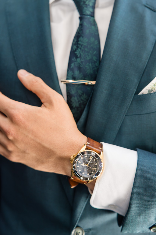 detail photo of groom wearing wristwatch