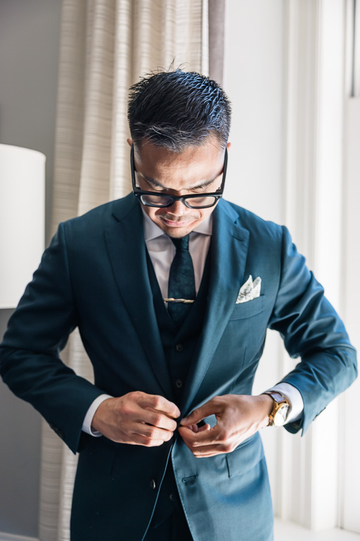 buttoning up suit jacket at th Palace Hotel