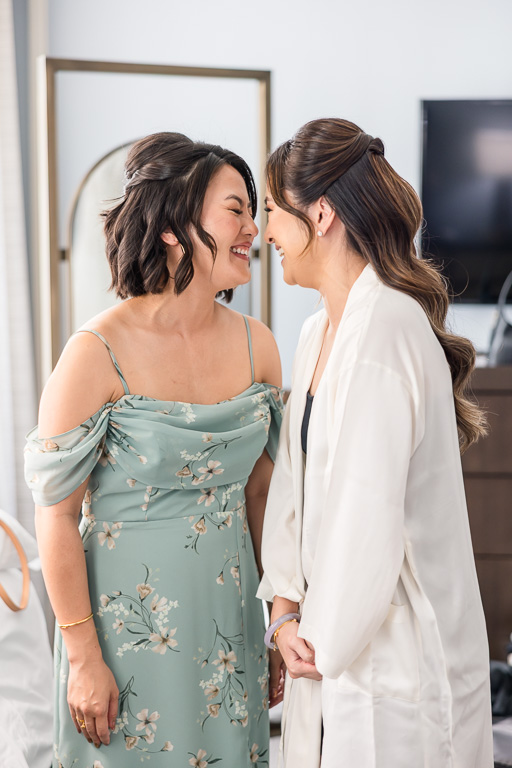 bride and sister of the bride sharing a moment during wedding prep