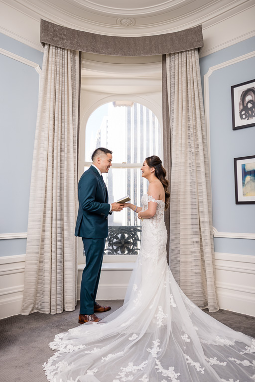 bride and groom sharing a moment during private vows inside their hotel room