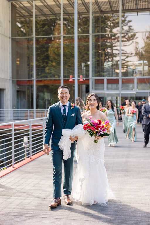 candid photo of couple and bridal party walking in Golden Gate Park