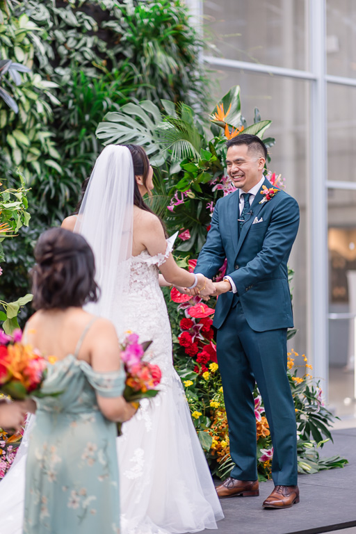 groom laughing during a moment of their wedding