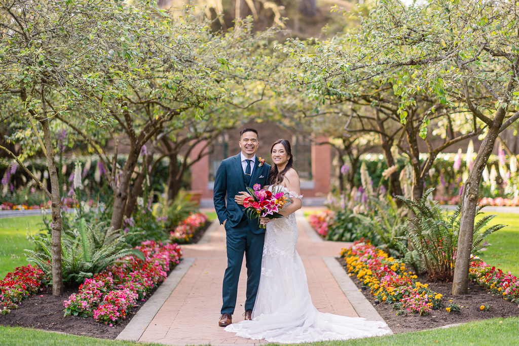 wedding photo of the couple in the tree lane at Shakespeare Garden