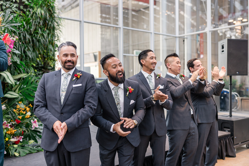 groomsmen cheering on the wedding processional of the bride