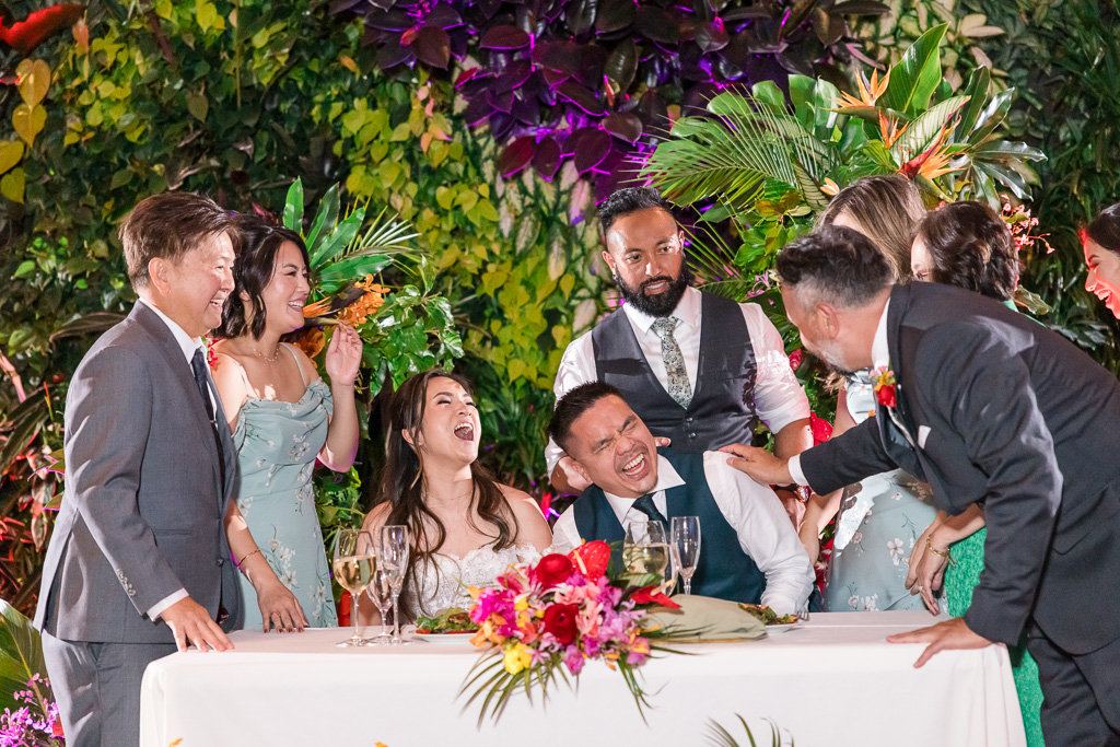 friends visiting the sweetheart table at the living wall