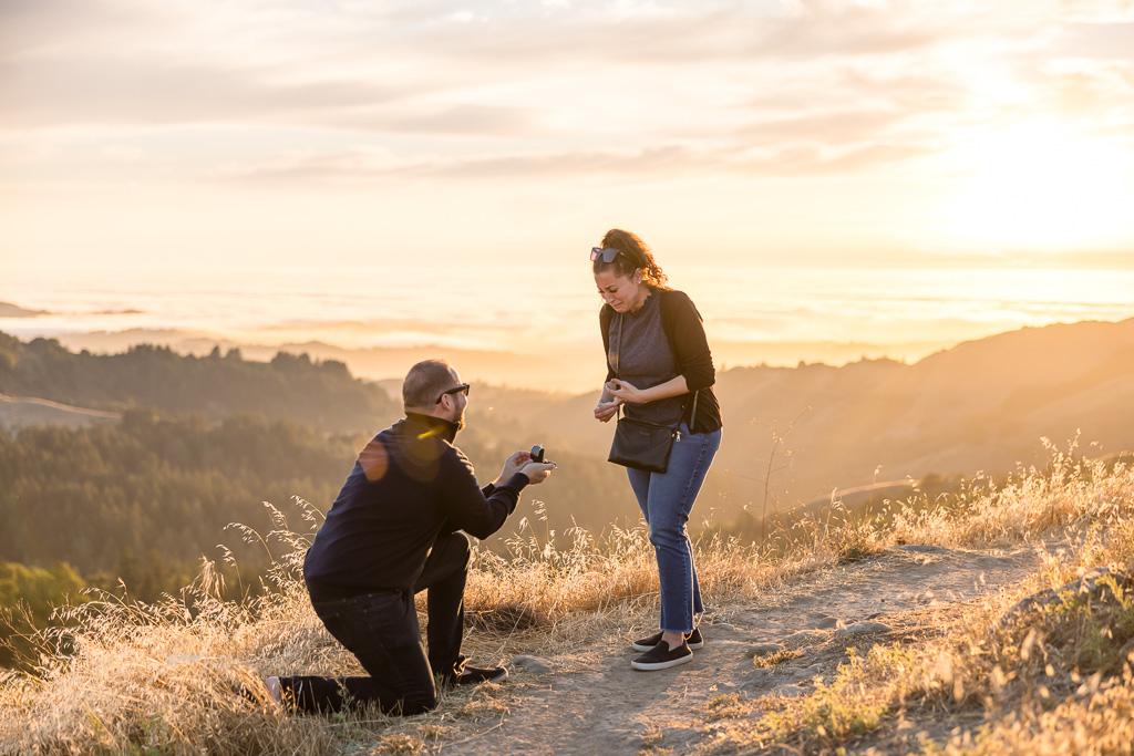 surprise proposal with golden glow and sun flare