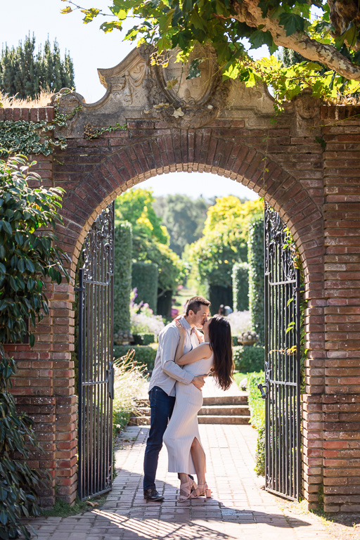 morning engagement photos at Filoli Gardens under a brick arch