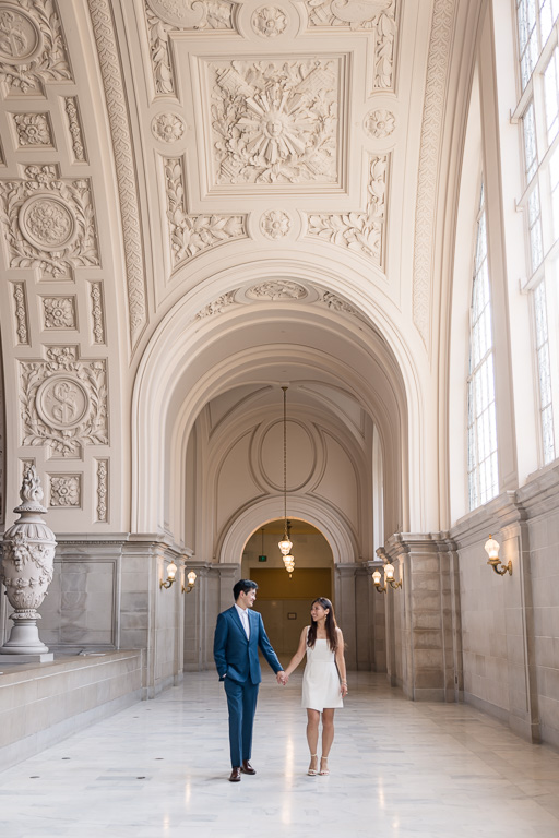 engagement photos showing off the arches of SF City Hall