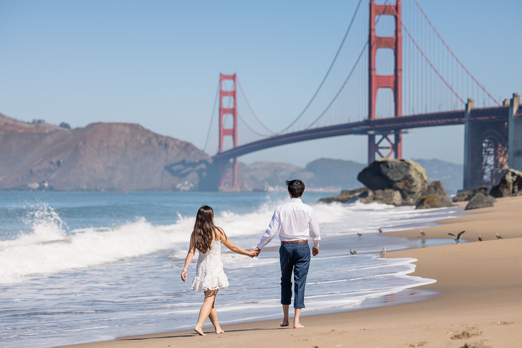 couple running along the shoreline of Marshall's Beach