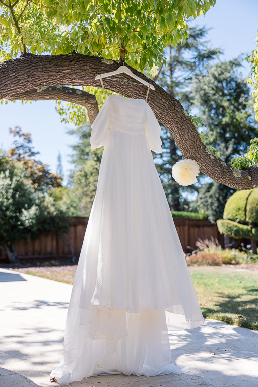wedding dress hanging from tree
