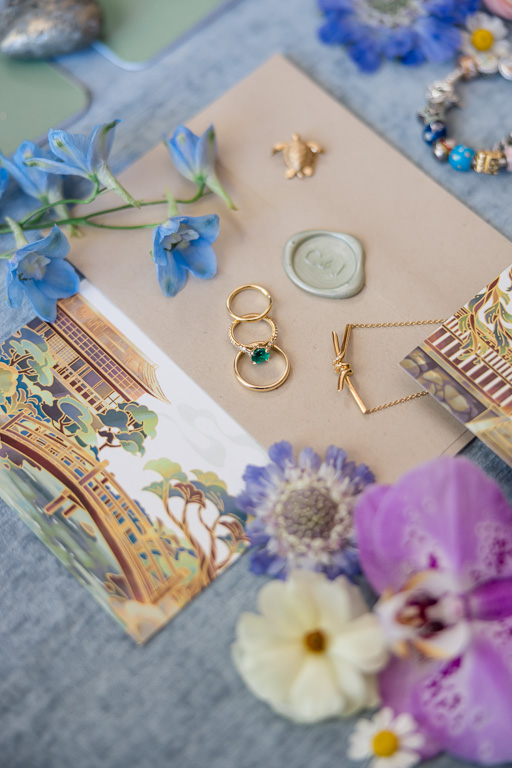 flat lay of wedding rings and custom wedding invitations with Japanese garden artwork