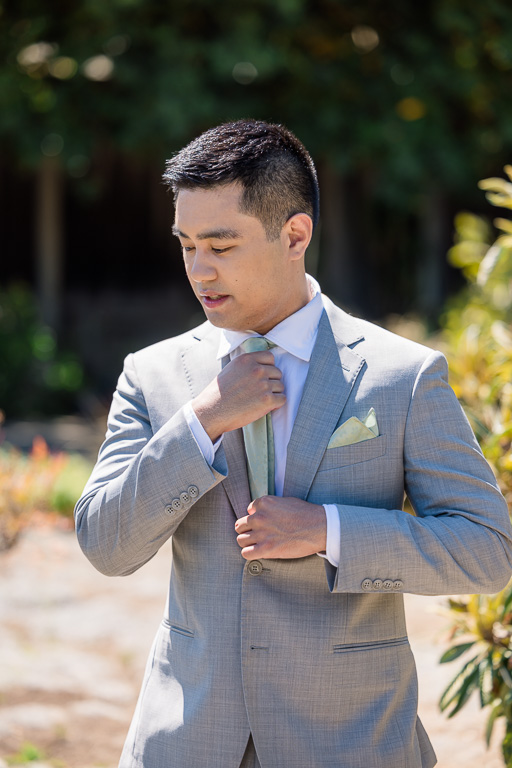 groom getting ready shot adjusting collar