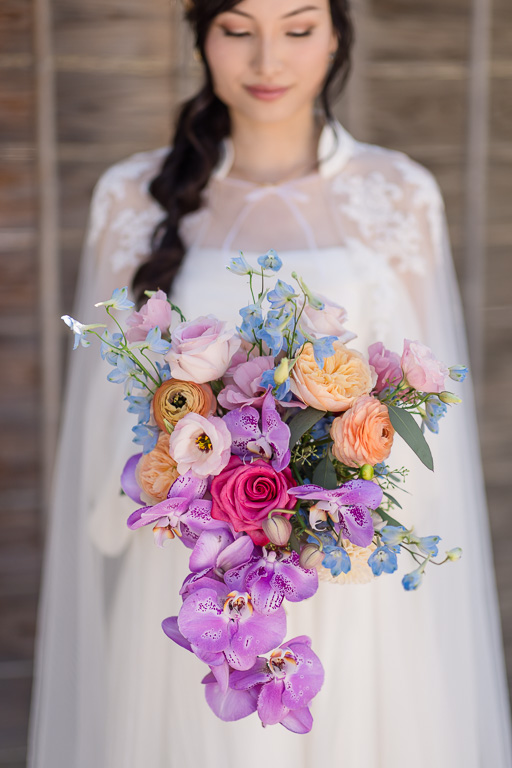 Elsa-inspired wedding dress and soft purple and magenta wedding bouquet