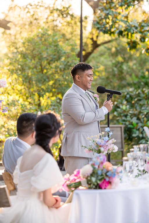 groomsman giving a dinner toast during golden hour at Hakone Gardens
