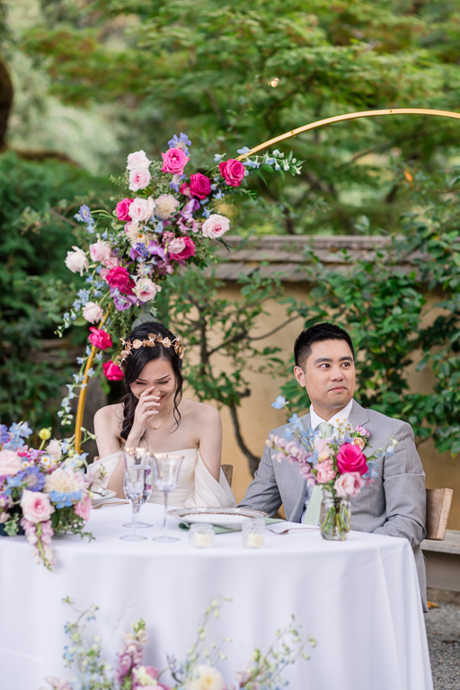 bride laughing at a bridesmaid speech