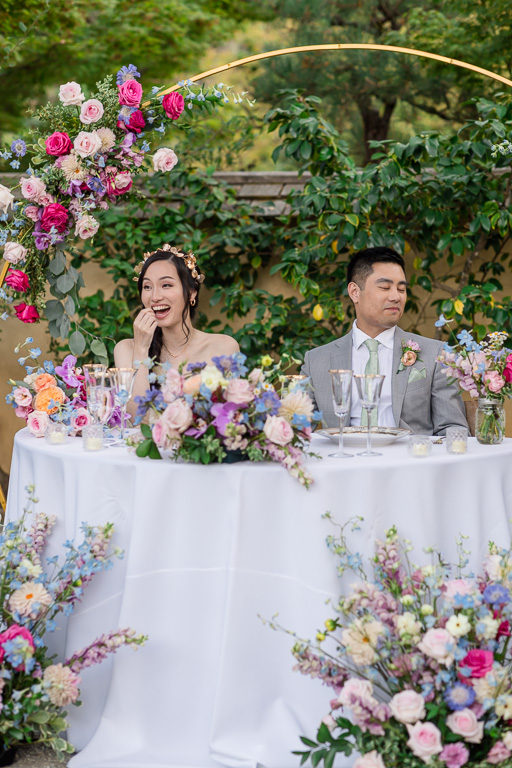 bride and groom laughing at a dinner speech