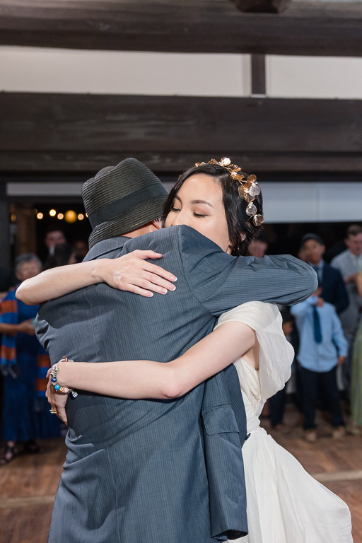 bride and dad sharing a hug