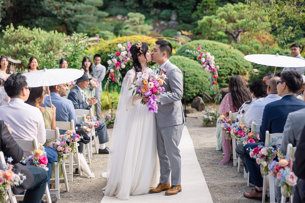 a kiss in the middle of the aisle after ceremony end