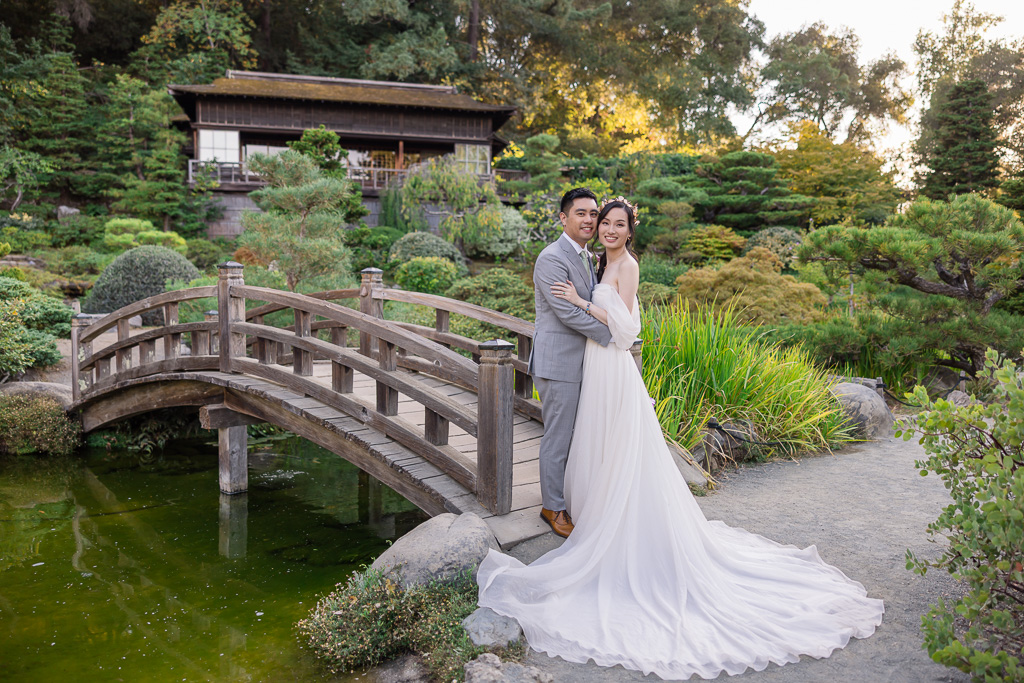bride and groom at Hakone Gardens wooden arch bridge