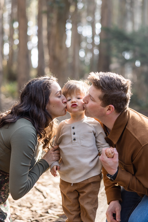 cute photo of parents kissing their son's cheeks