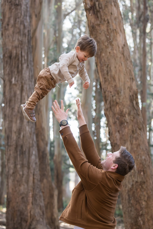 dad tossing son up into the air