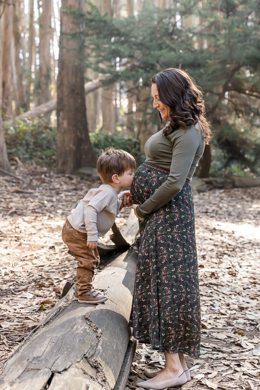 toddler kissing mommy’s belly