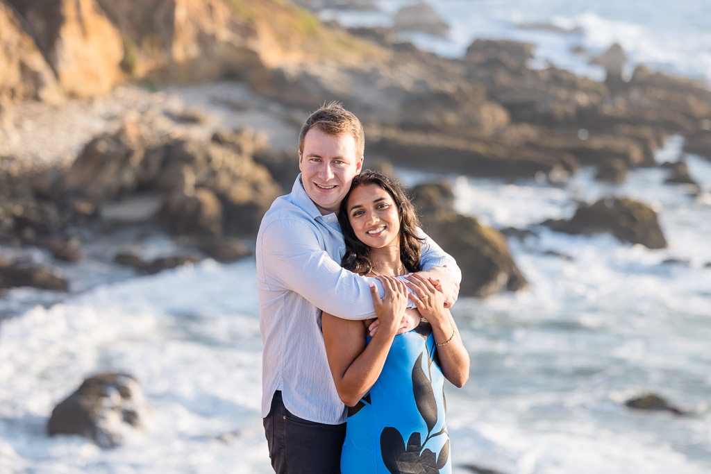 romantic engagement photos on the rocks above the ocean on a cliff