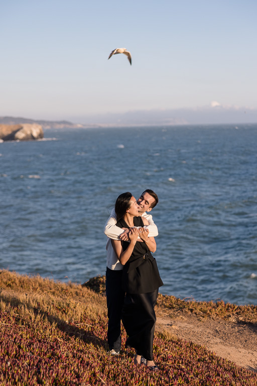 couple photo with seagull flying overhead