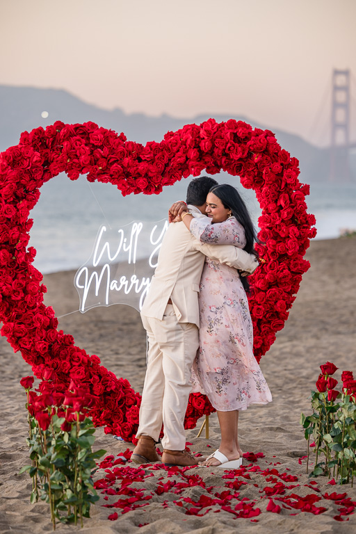proposal on the beach with roses and candles