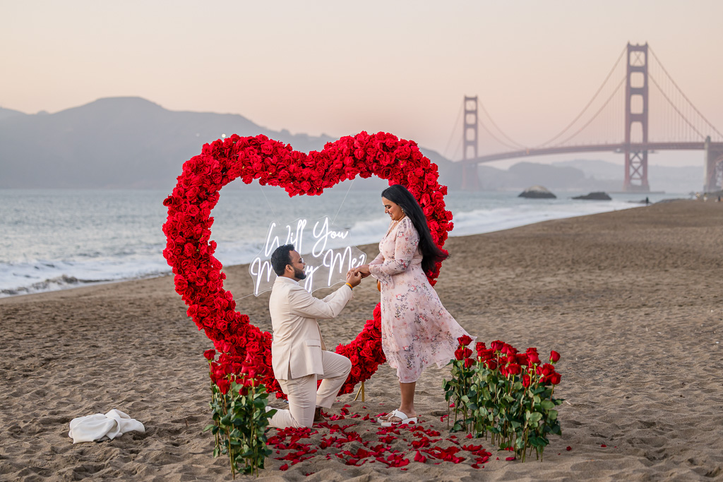 proposal with floral heart backdrop