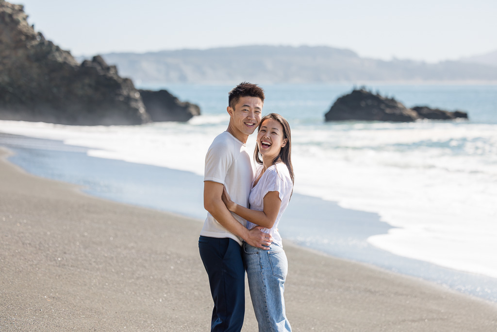 a casual engagement photo on the beach