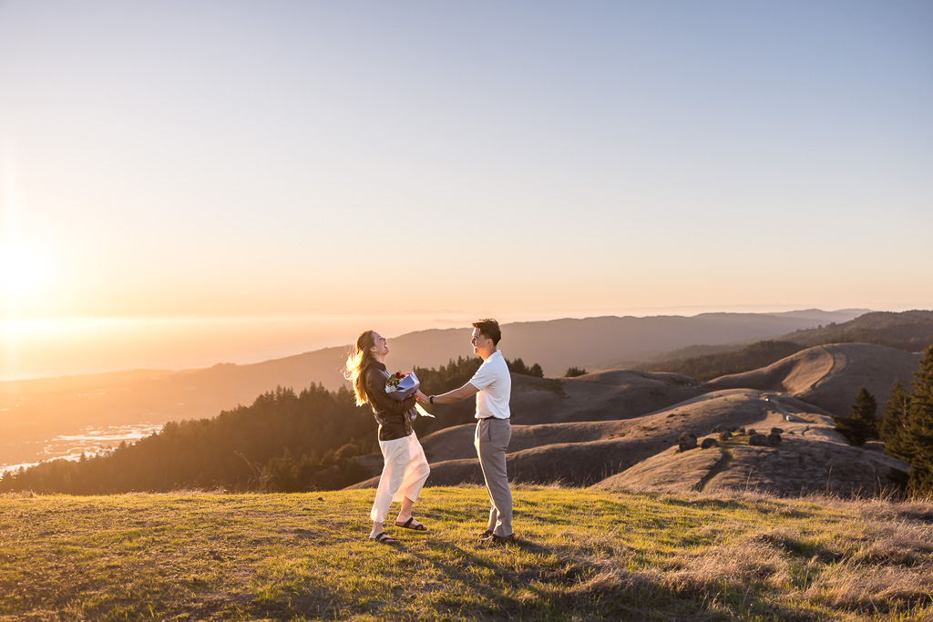 laughing in joy as she realizes this is a surprise proposal
