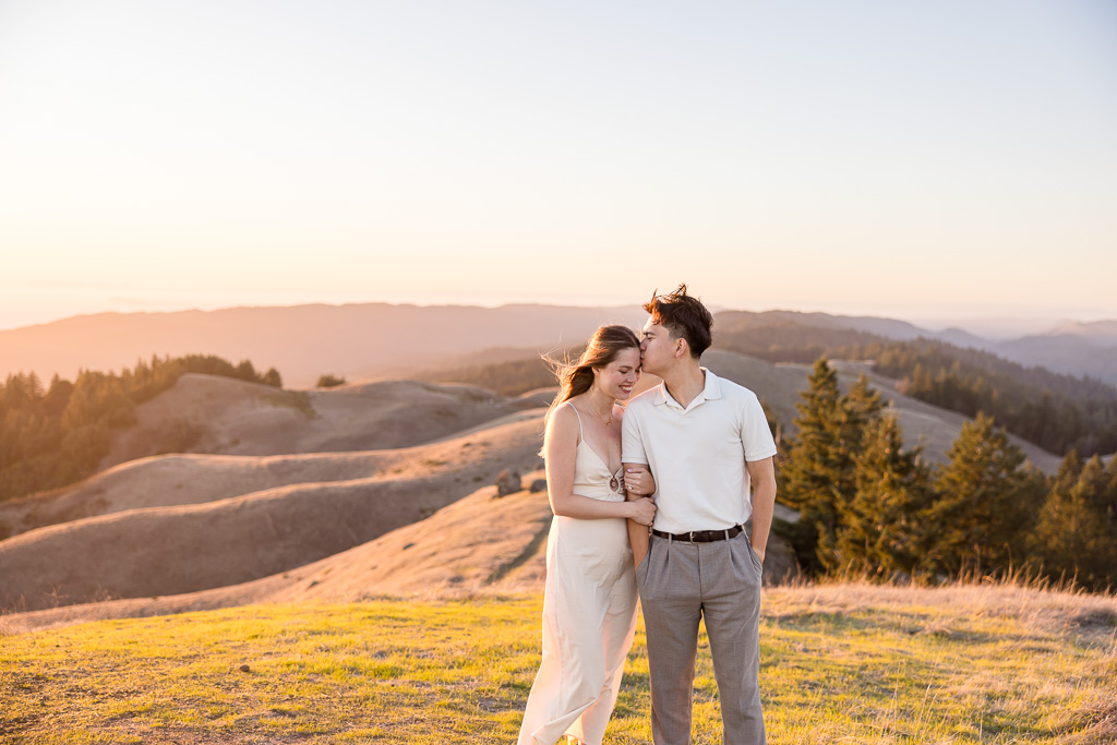 engagement photos with golden rolling hills in the background at sunset