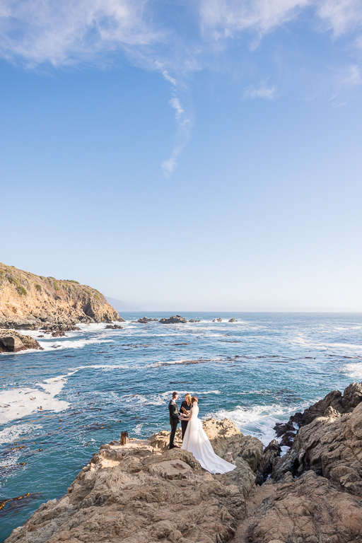 Big Sur elopement couple embracing at Partington Cove with coastal cliffs