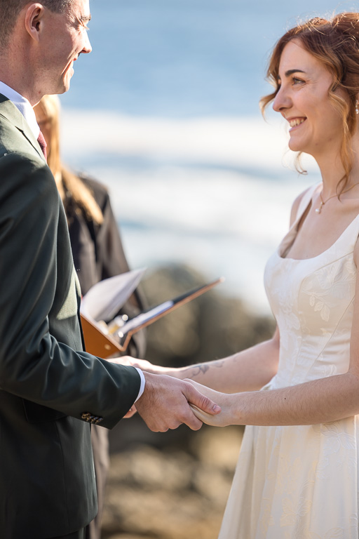 an intimate moment between bride and groom holding hands during elopement