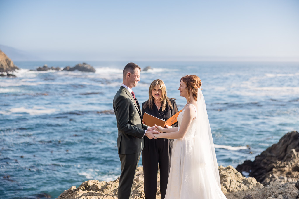 Big Sur Partington Cove elopement couple embracing dramatic coastal setting intimate ceremony