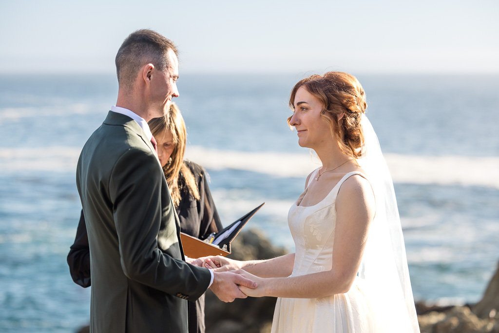 Big Sur Partington Cove elopement couple standing on rocky coastal cliffs ocean sunset