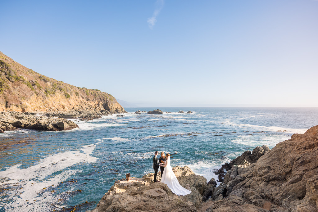 wide angle shot of couple having an intimate elopement at Partington Cove on the ocean bluffs