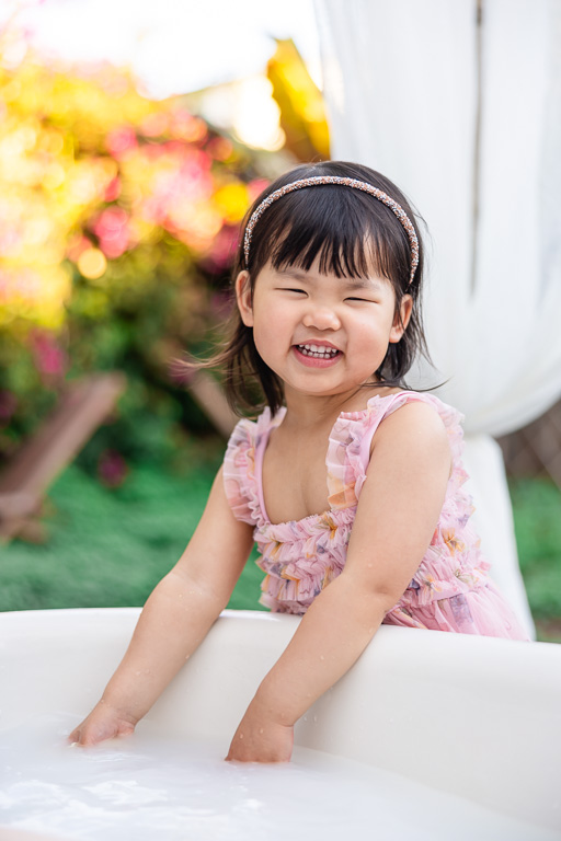 cute little toddler playing with water