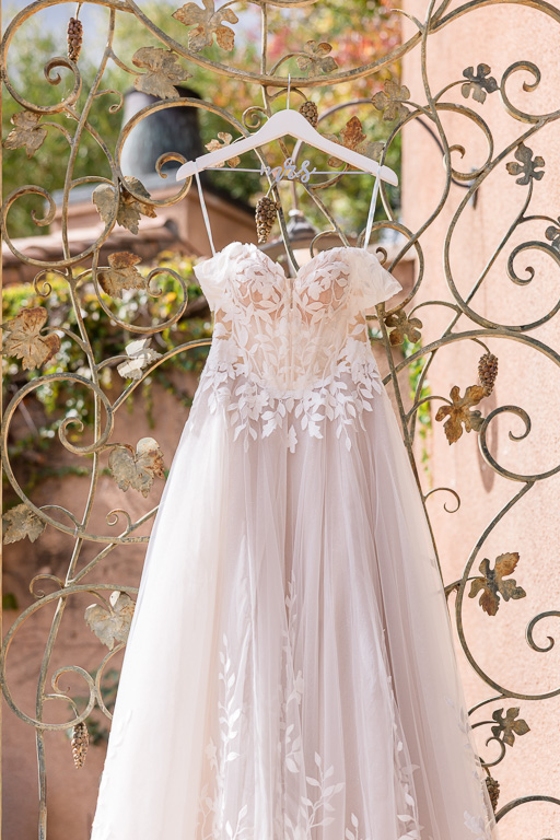 elegant wedding dress hanging on metal wire door