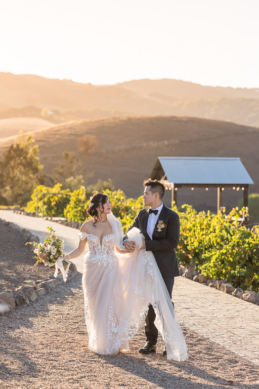 golden hour sunset wedding photo against the vineyards and hills in the background