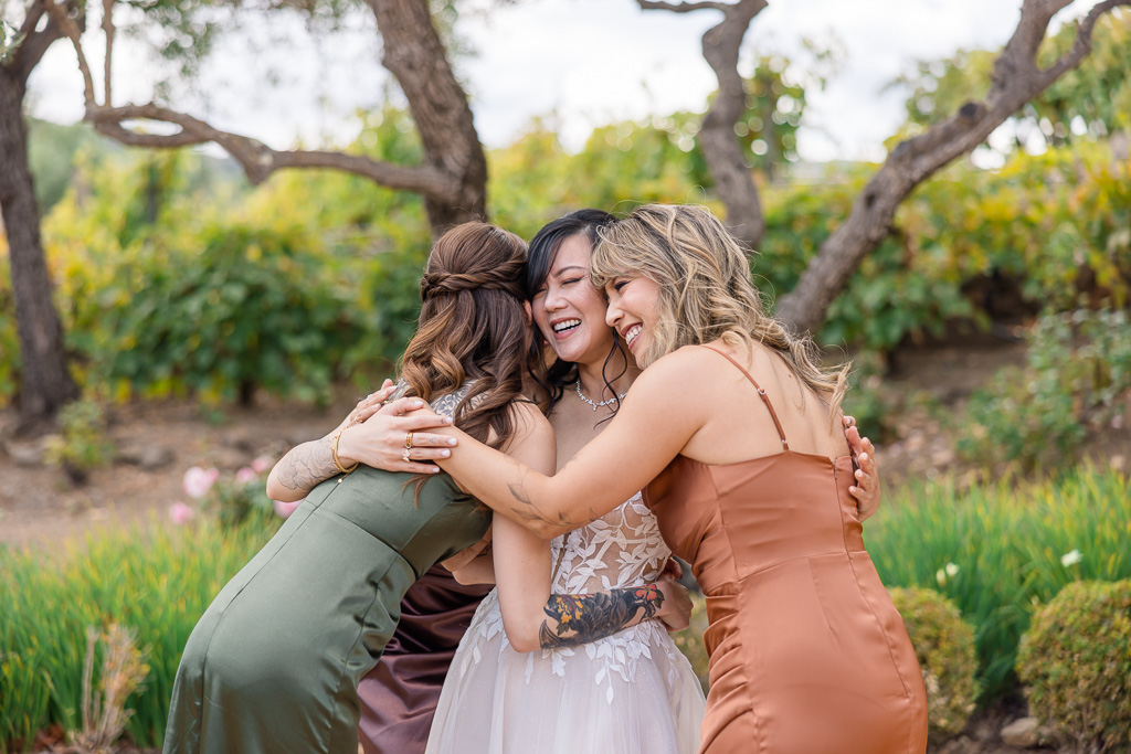 bride hugging her bridesmaids