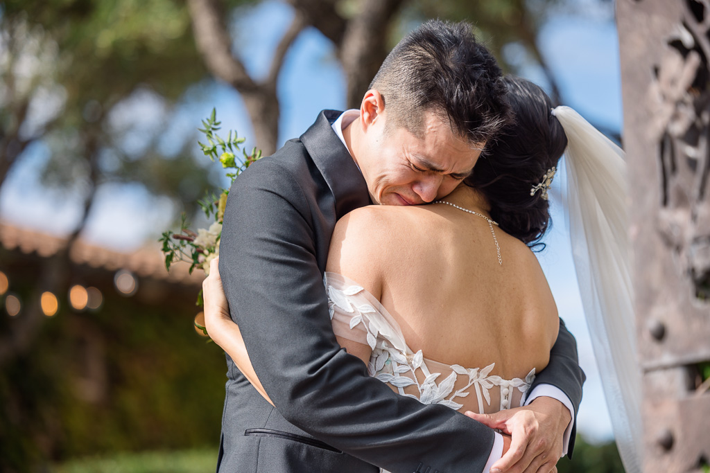 a deeply emotional moment between the bride and groom at their first look