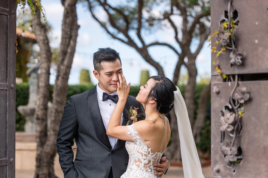 bride wiping a tear from the groom's eye